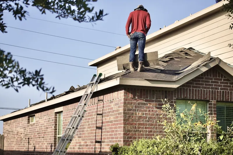 Professional roofer working on a residential roof in Donner